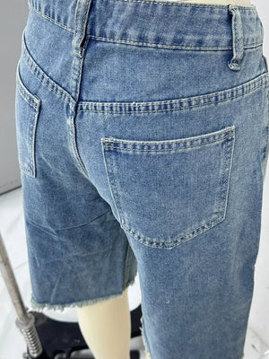 Blue denim bermuda shorts with frayed hem and belt loops.