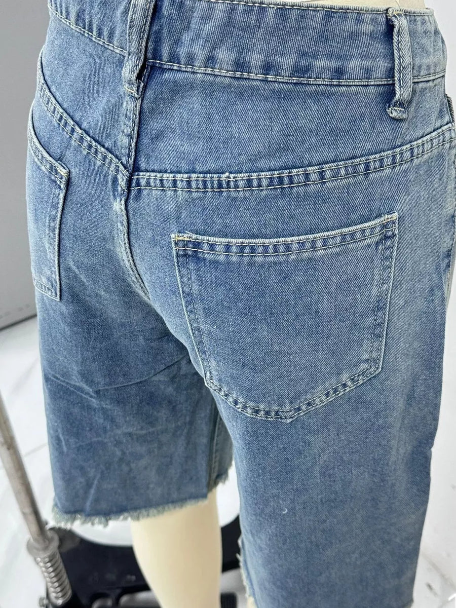 Blue denim bermuda shorts with frayed hem and belt loops.