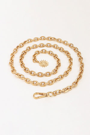 Gold chain waist belt with sunburst charm and lobster clasp closure