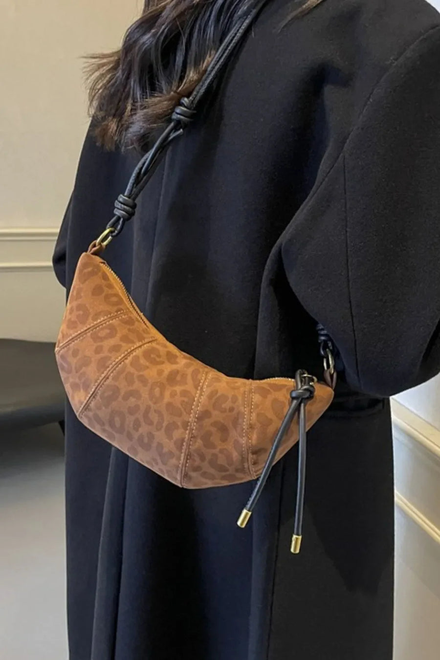 Brown leopard print crescent shoulder bag with knot detail and gold hardware