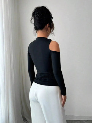 Black one-shoulder t-shirt with cutout detail and long puff sleeves.