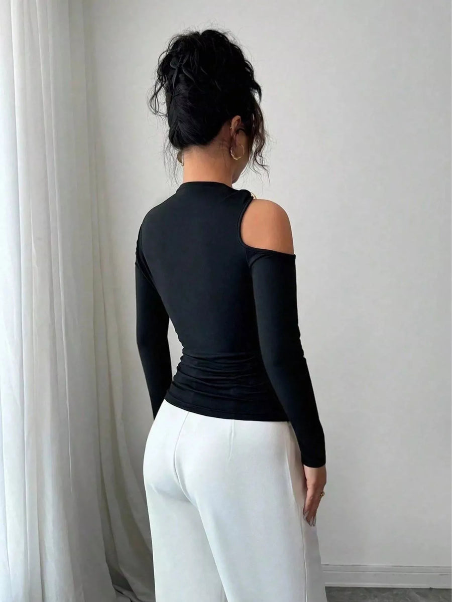 Black one-shoulder t-shirt with cutout detail and long puff sleeves.