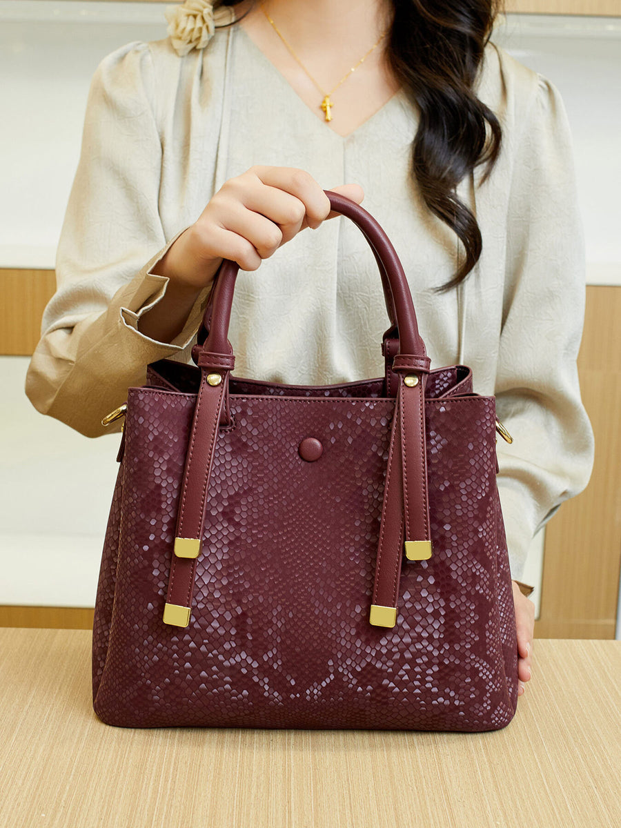 handbag in burgundy with snakeskin and top handles