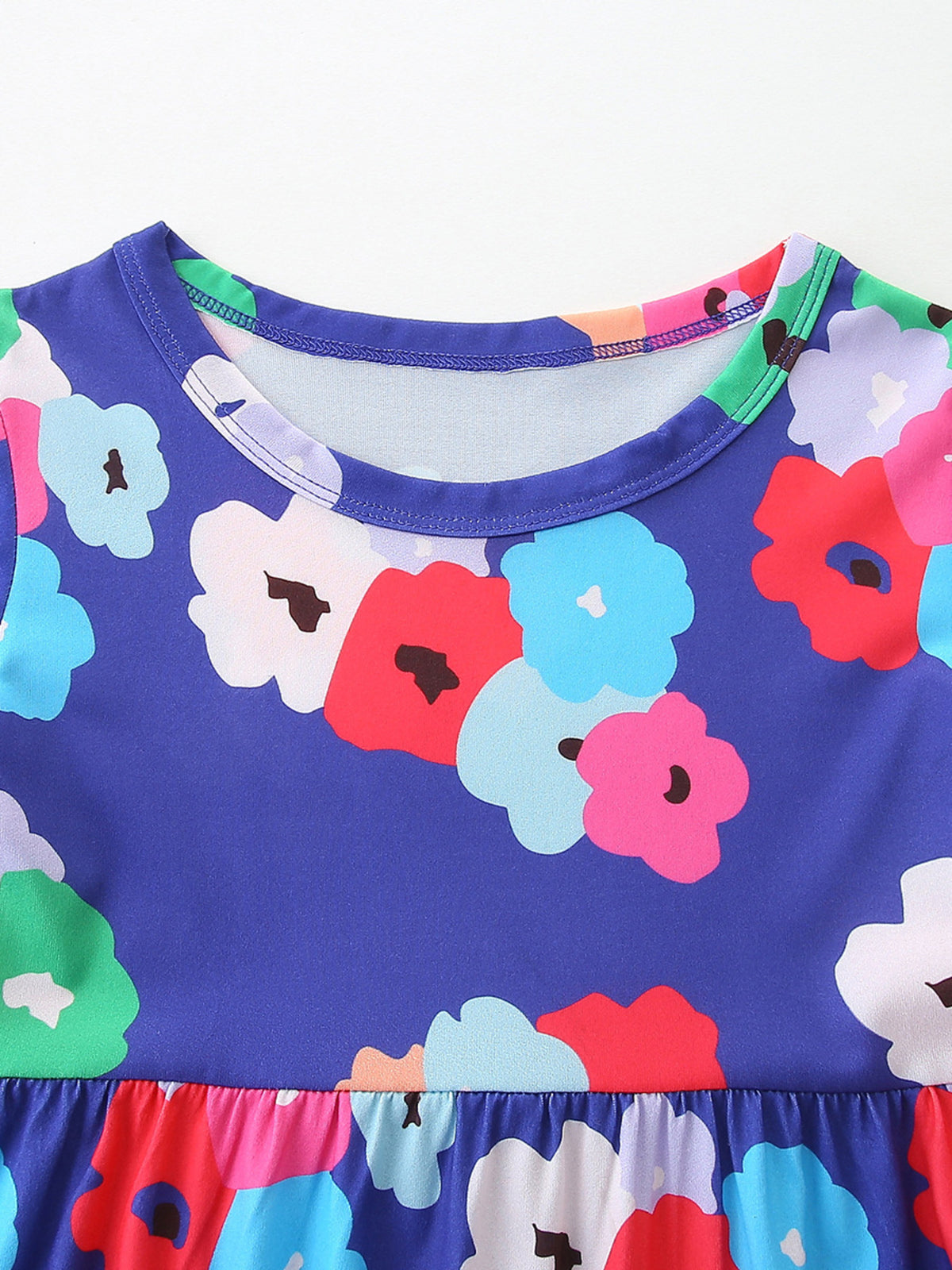 Toddler A-line dress in blue with a vibrant floral print and ruffled hem.
