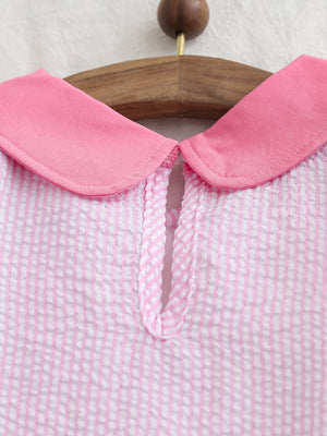 Baby dress with pink collar and seersucker check fabric