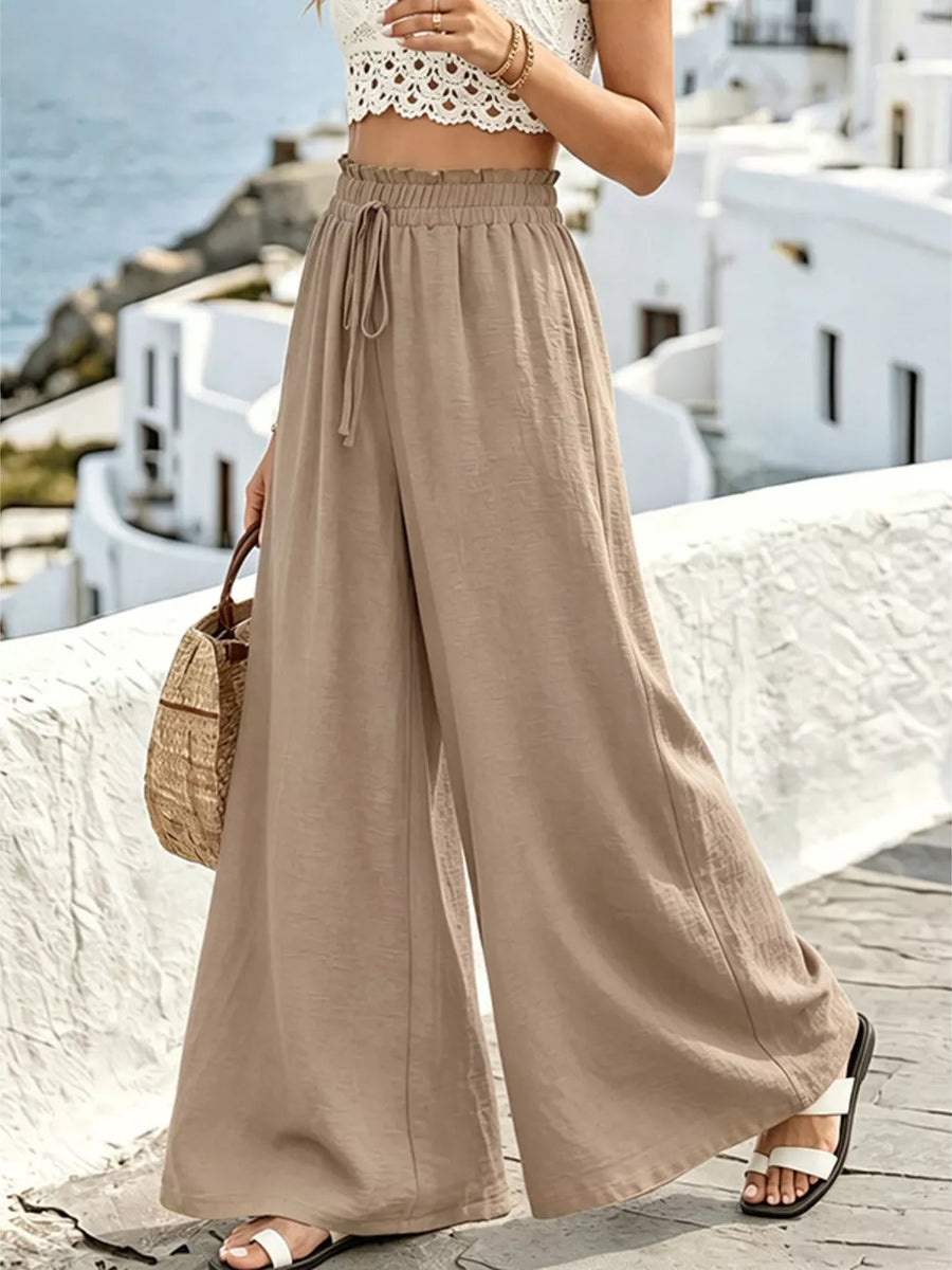 Tan linen wide-leg pants with drawstring waist and ruffled detail
