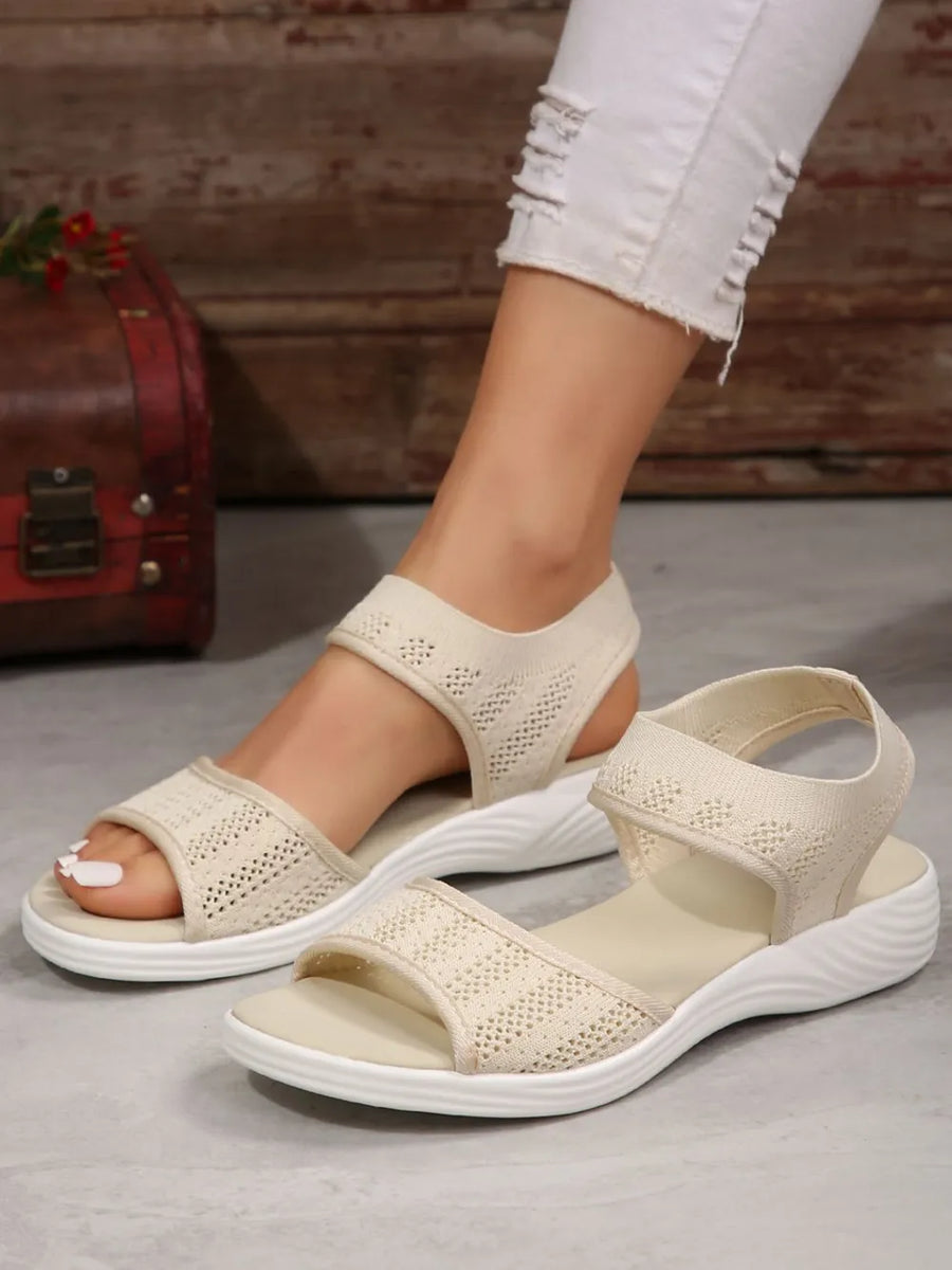Beige shimmer mesh peep sandals with white soles and ankle straps.
