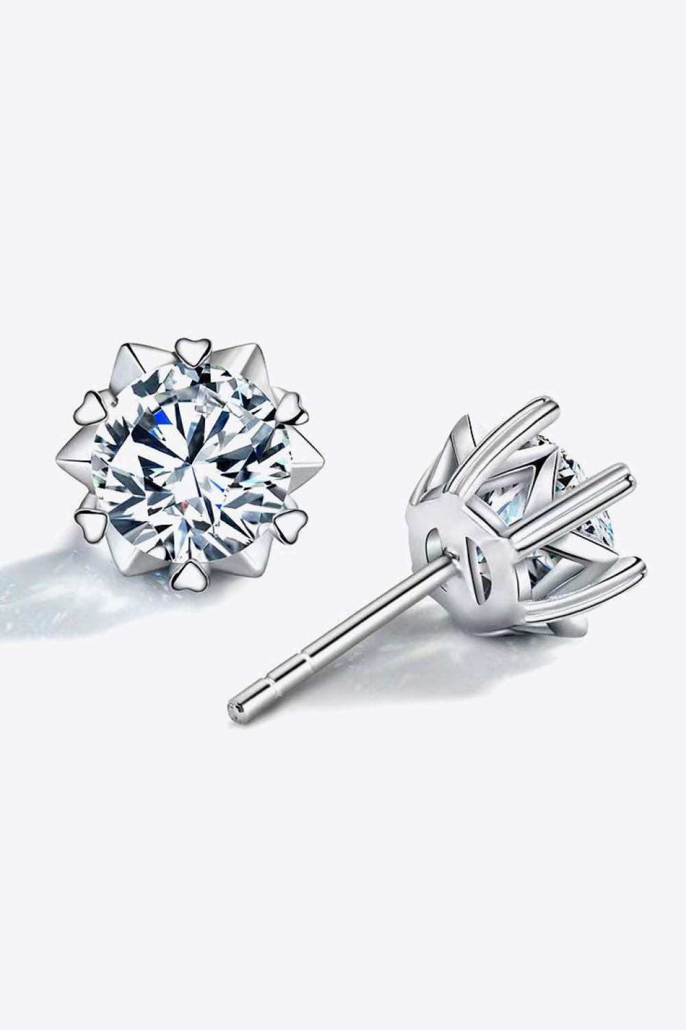 Silver stud earrings with a celestial cut moissanite and heart details.