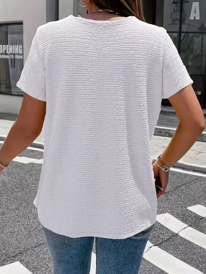 Textured white short sleeve blouse with a crew neck, shown from the back.