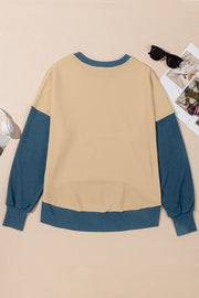 Chic Contrast Crewneck Sweatshirt in tan with blue sleeves and trim.