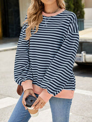 Striped crew neck sweatshirt in navy and light blue with coral cuffs and hem.