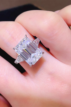 Silver ring with large emerald cut diamond and two side trapezoid diamonds