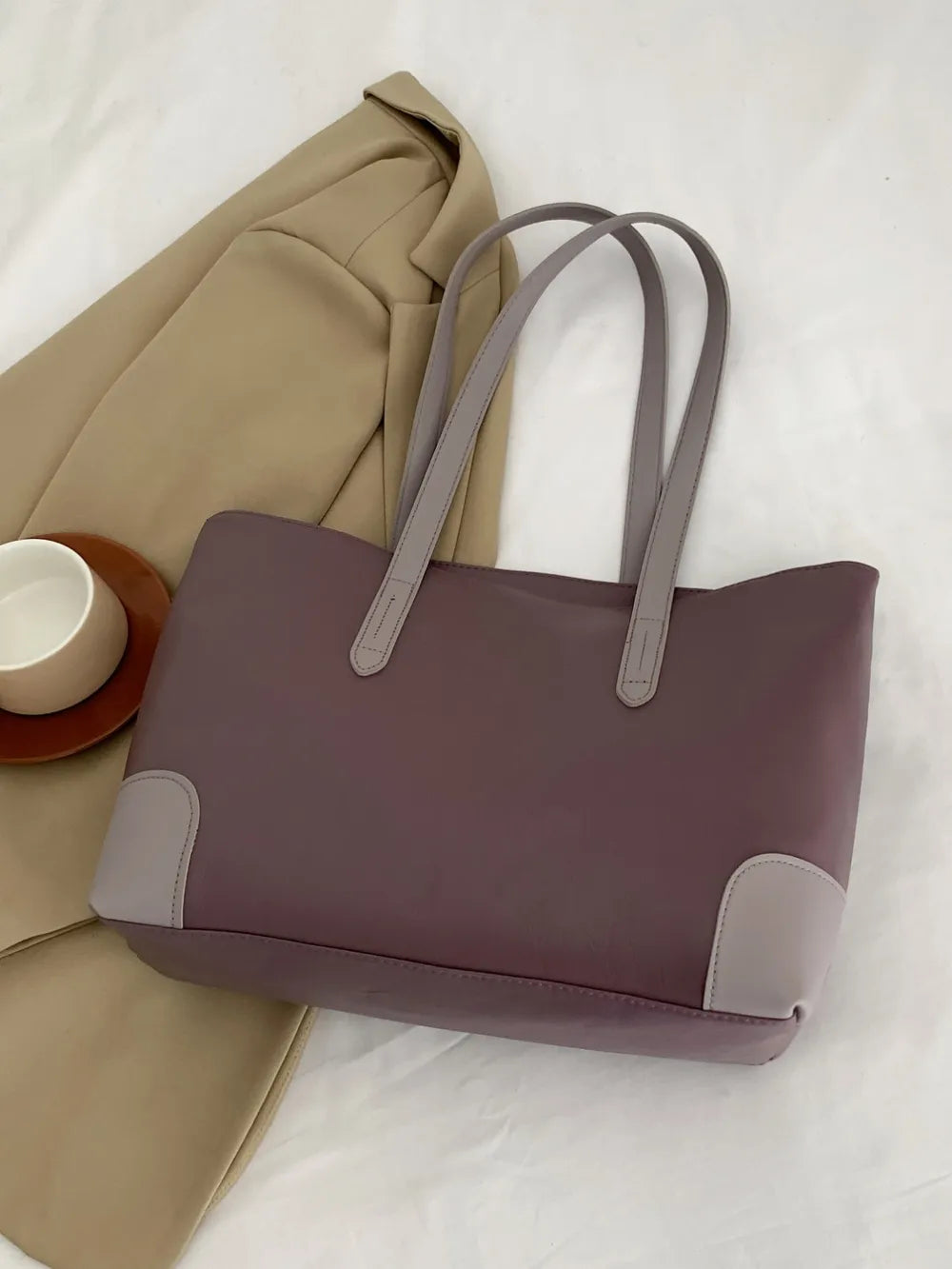 Two-tone panel tote shopper bag in mauve with grey accents and handles.