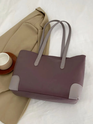 Two-tone panel tote shopper bag in mauve with grey accents and handles.