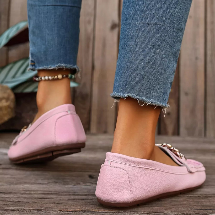 Pink round-toe loafers with chain detail and textured leather.