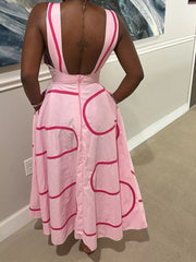 Pink midi dress with abstract pattern, square neck, and deep V-back.