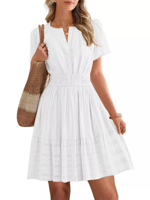 White textured V-neck tiered dress with smocked waist and short sleeves
