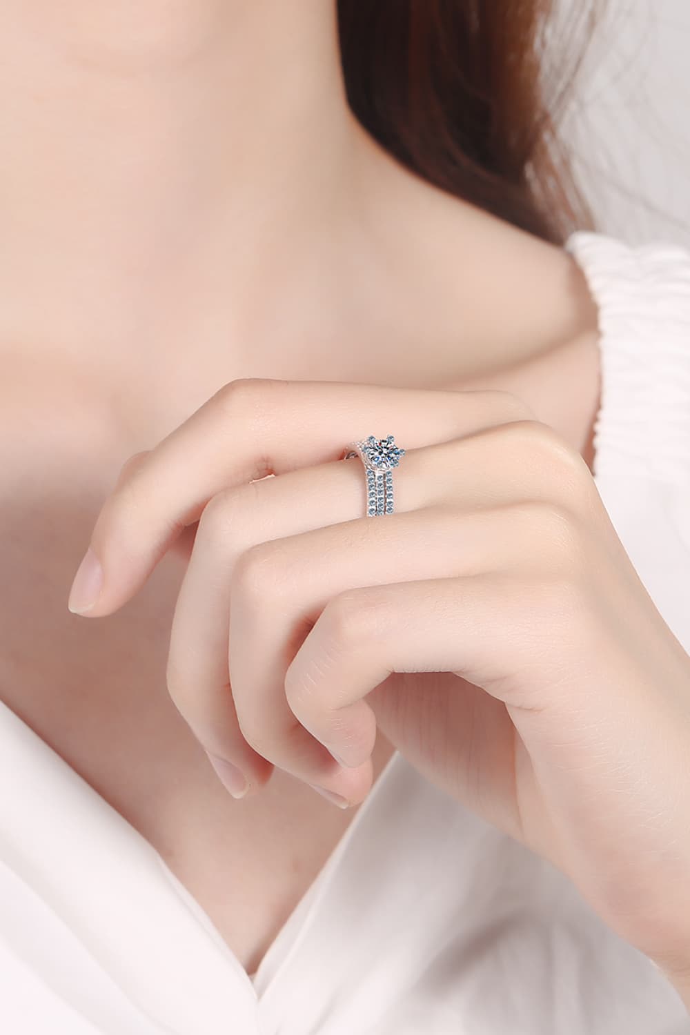 Silver celestial cluster ring trio with sparkling stones on a hand.