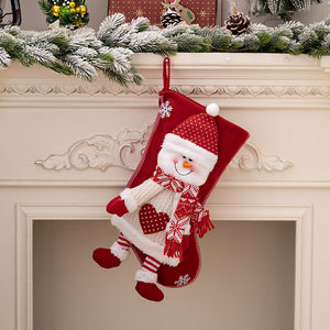 Red Christmas stocking with plush snowman, festive scarf, and snowflake details.