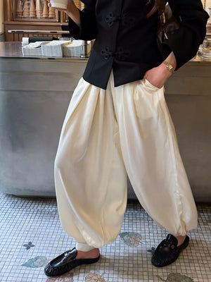 100% polyester Care instructions: Machine wash cold wide-leg pants in ivory with loose silhouette