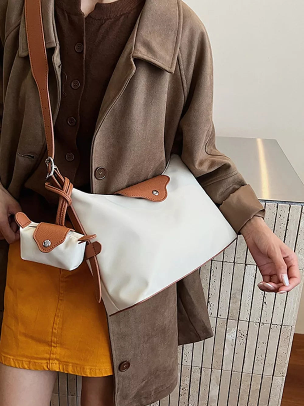 Ivory canvas hobo bag with brown trim and matching coin purse.
