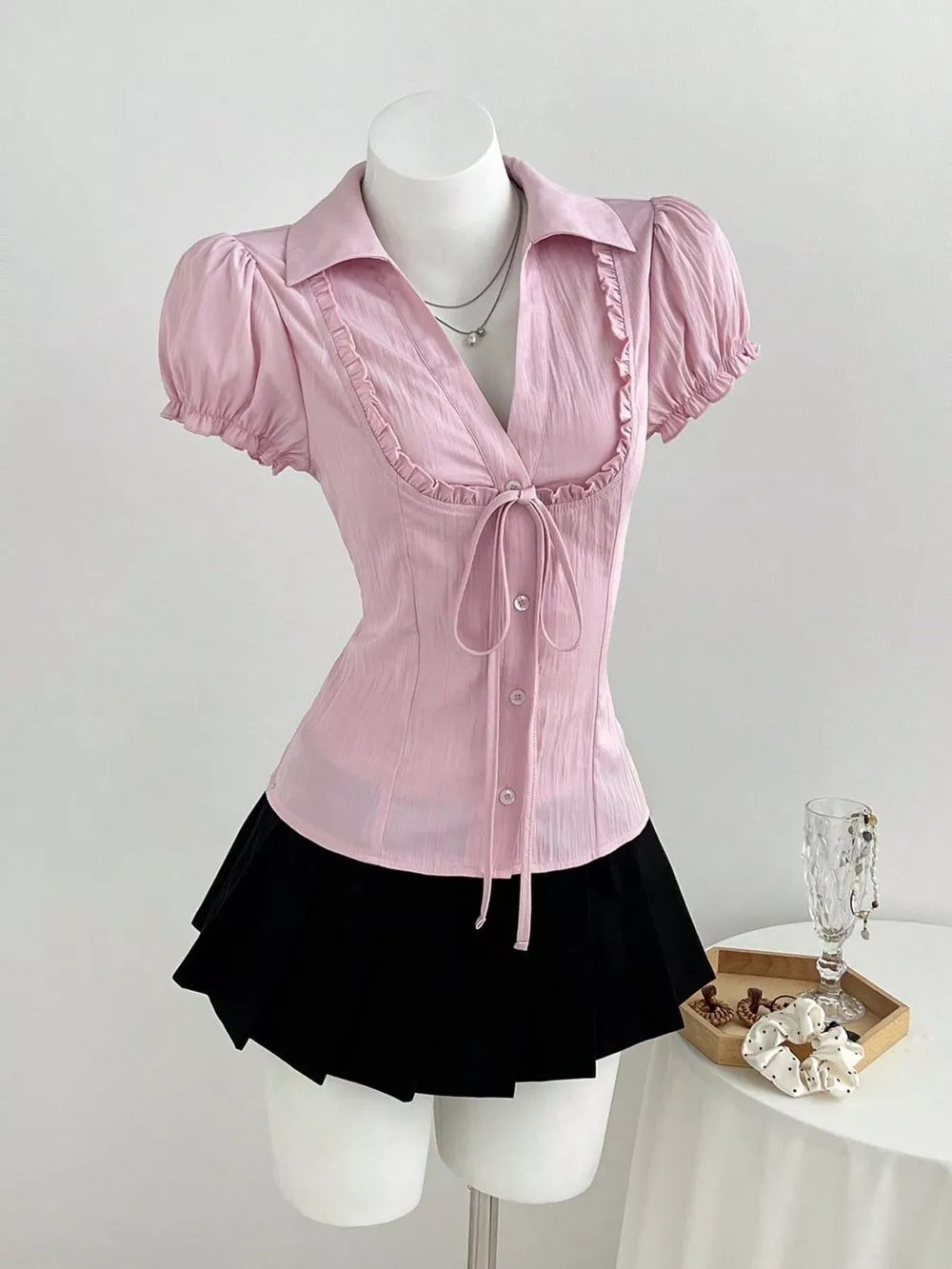button-up shirt in light pink featuring tied and fitted fit