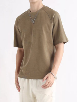 Men's brown relaxed fit cotton t-shirt with raglan sleeves and crew neck.