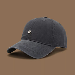 Dark gray baseball cap with embroidered R detail and curved brim.