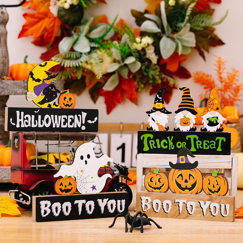 Halloween gnome trio display with pumpkins, ghost, and spider decor.