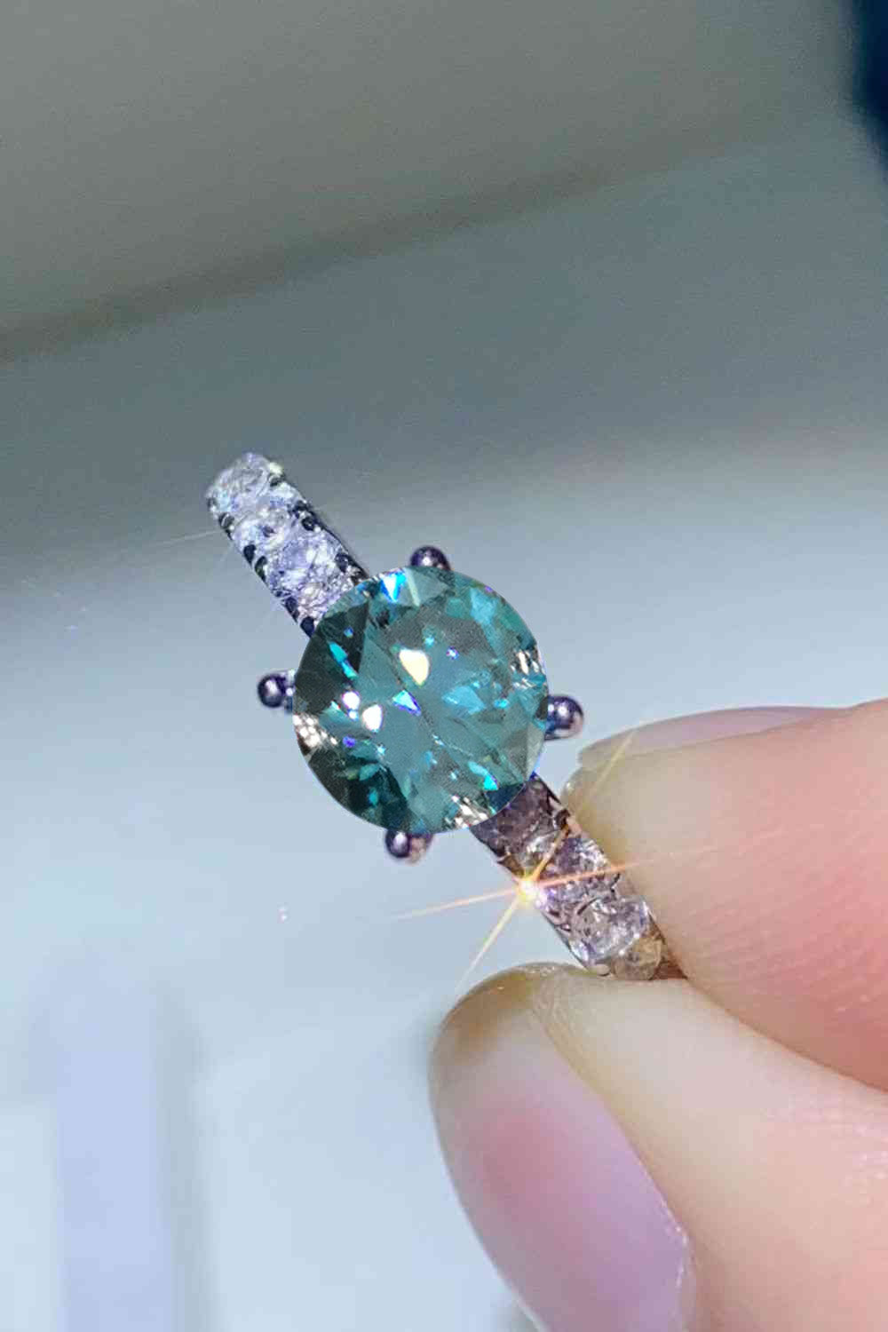 Celestial teal moissanite ring with pavé band in sky blue
