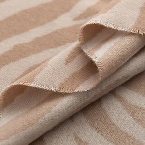 Zebra stripe wool scarf in khaki with frayed edges.