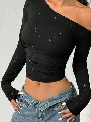 one-shoulder top in black featuring glitter and fitted fit