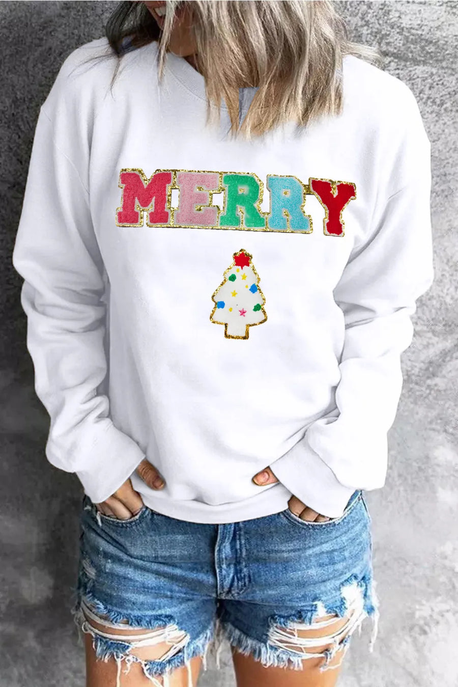 White sweatshirt with "MERRY" appliqué and Christmas tree graphic