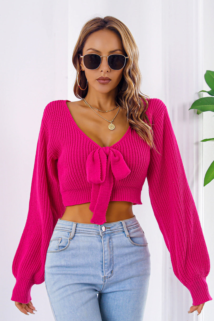 Tie-front balloon sleeve crop knit sweater in Deep Rose acrylic with V-neck.