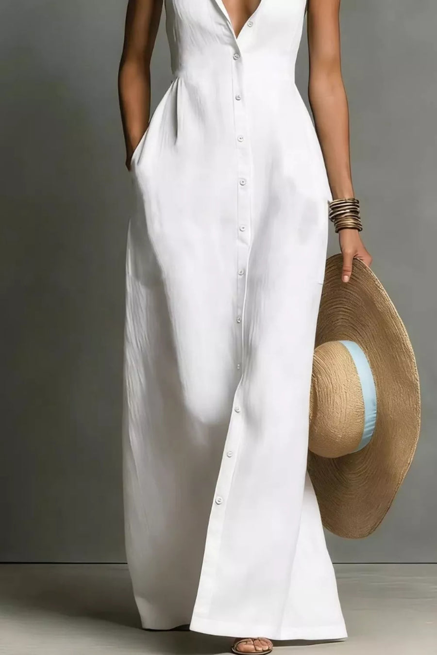Chic white sleeveless maxi dress with button front and pockets, styled with a straw hat.