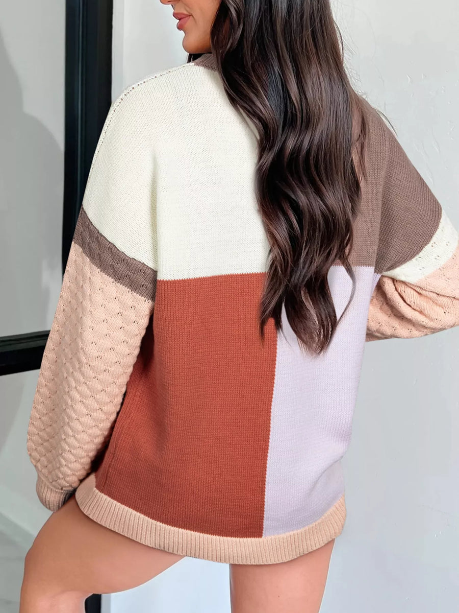 Multicolor ribbed knit sweater with colorblock design and textured sleeves.