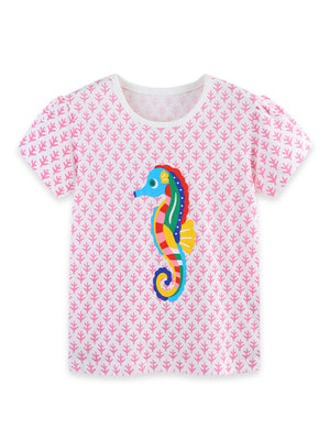 White cotton crew neck t-shirt with pink leaf pattern and colorful seahorse graphic.
