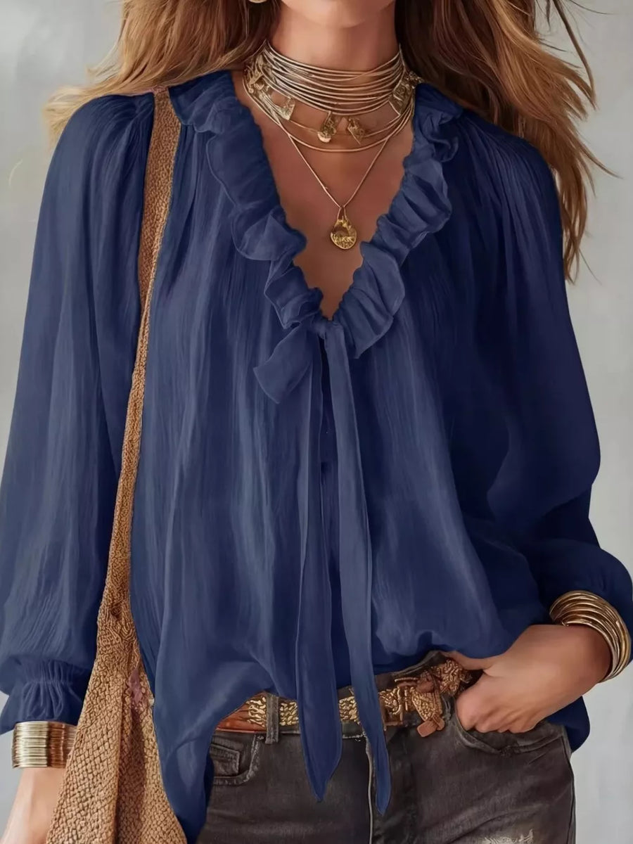 Navy frilled tie-front shirt with long sleeves and a V-neckline.