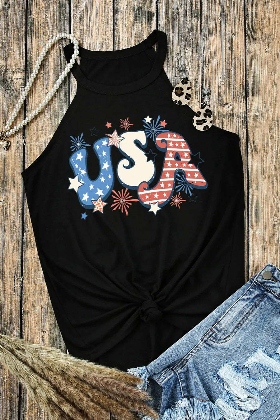 Black halter tank top with patriotic USA graphic and knotted hem.