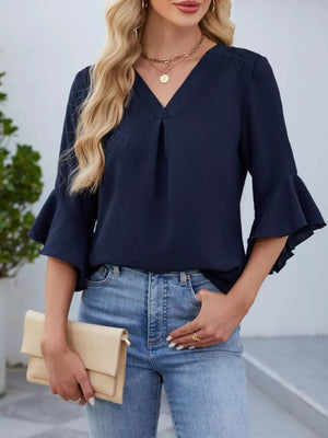 Navy V-neck ruffle sleeve blouse with textured fabric and pleated detail.