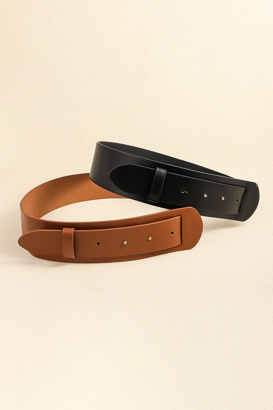 Sculpted leather waist belts in black and caramel with adjustable buckle closure.