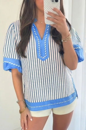 Vibrant stripe color block V-neck shirt with decorative stitching and blue trim.
