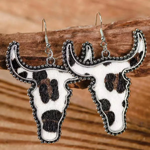Cow print bull head drop earrings with beaded silver-tone trim.