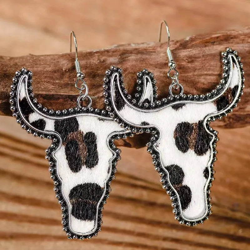 Cow print bull head drop earrings with beaded silver-tone trim.