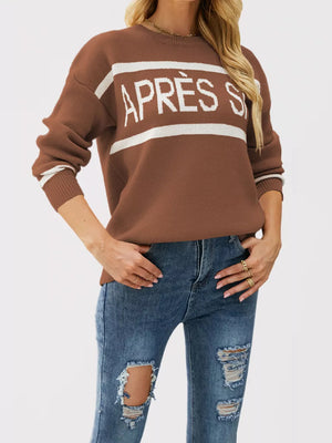 white crewneck sweater featuring ribbed cuffs and graphic