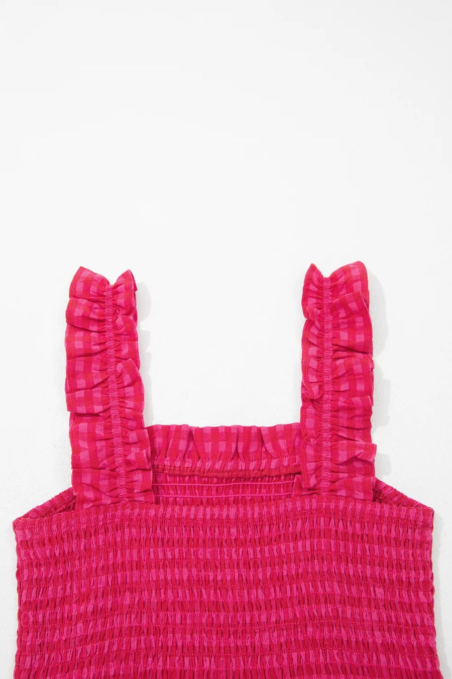 Pink gingham sundress with smocked bodice and ruffled straps.