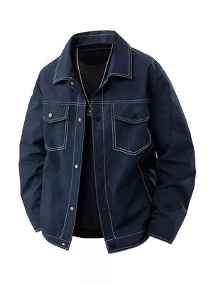 Oversized denim trucker jacket in dark blue with white contrast stitching and snap buttons.