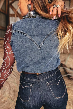 Blue denim button front sleeveless vest with western yoke detail.