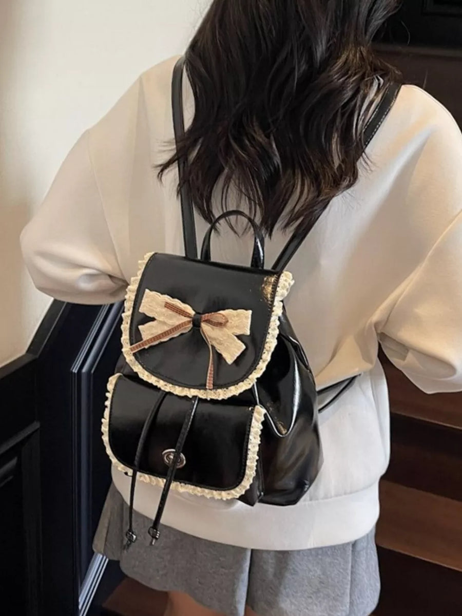 Black mini backpack with lace trim and bow detail