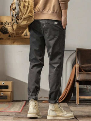 Men's dark gray slim fit ankle pants with a back pocket detail.